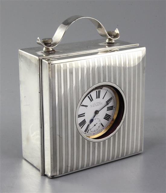 A plated Goliath pocket watch by J C Vickery, in silver mounted illuminating square case with strap handle and interior compartment, 6.
